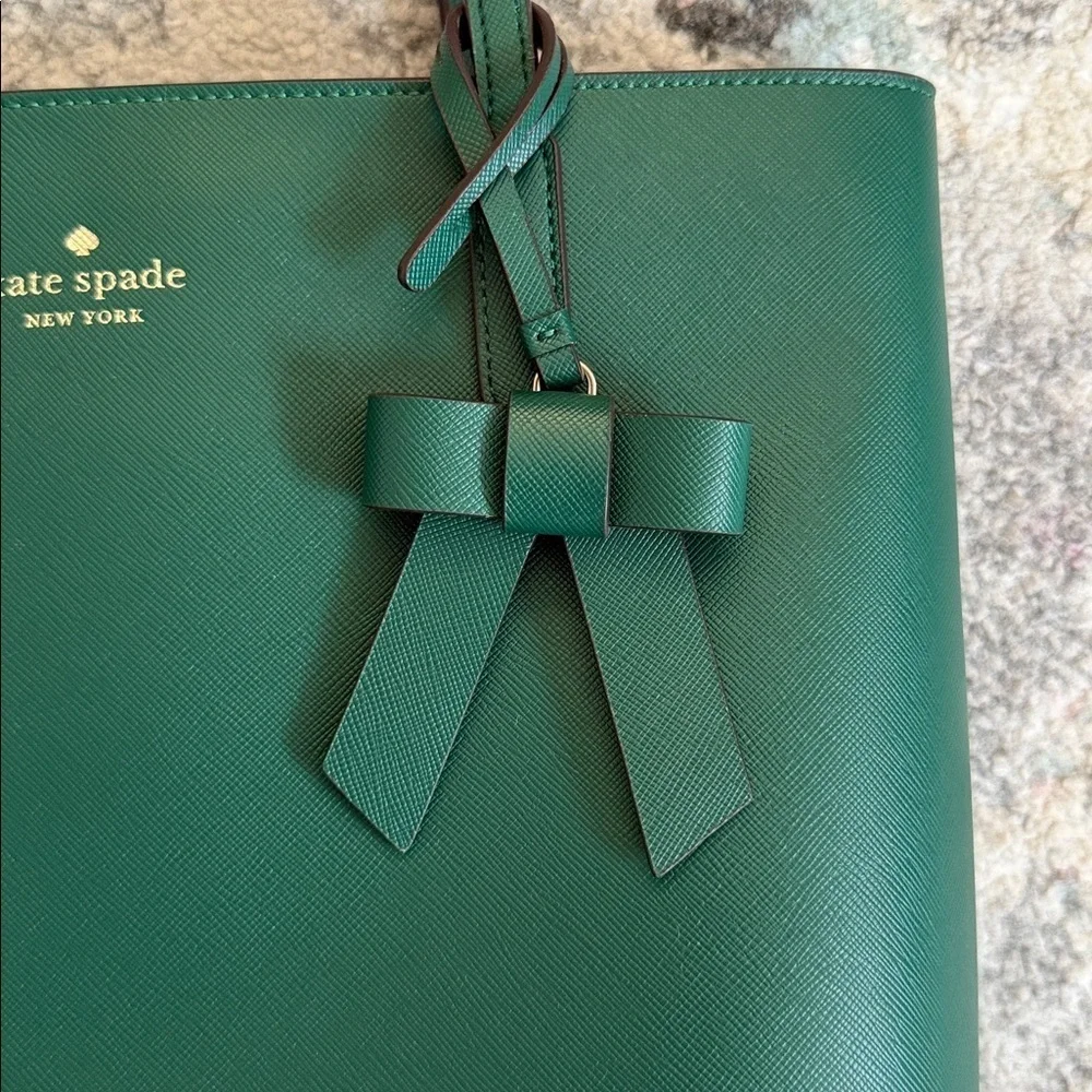 Kate Spade Brynn leather tote bag in the deep jade color with bow charm